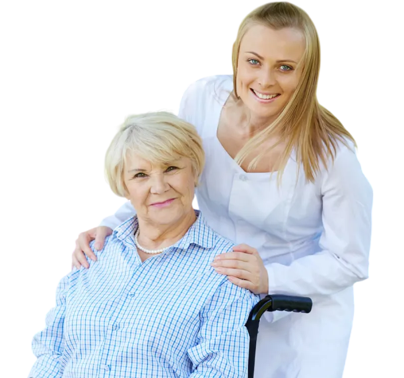 A caregiver in a white uniform poses with a hand on the shoulder of an elderly woman holding a cane.